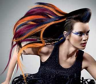 fig.: Nomad Couture is inspired by the effects of modern mobility. Different inspirations come together to create new things that transcends cultural and regional barriers. A life without limits that opens up new perspectives that go beyond our imagination.The hair has a structured cut that is showcasing a mix of different textures and styles in one look. The colors are reflecting a rainbow of bright, neon color, reddish brown tones, hot bright accents. 